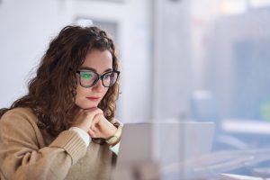 Young woman wearing glasses using a computer