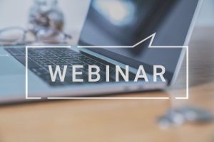 A laptop with the word webinar