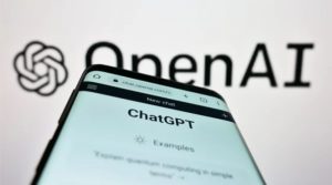 A mobile phone with ChatGPT open sits in front of the OpenAI logo.