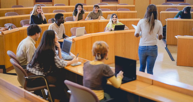 Students actively engaged in a lecture in a university classroom.